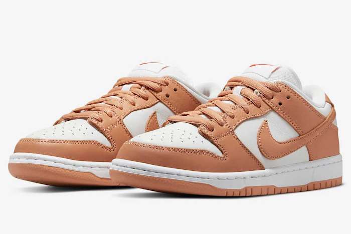 Tan and white Nike Dunk shoes.